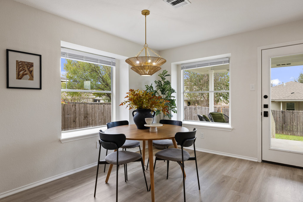 1305 Tudor House Road Pflugerville, TX 78660 - Photo 18 of 40 This dining space connects seamlessly to the backyard, blending indoor comfort with outdoor enjoyment.