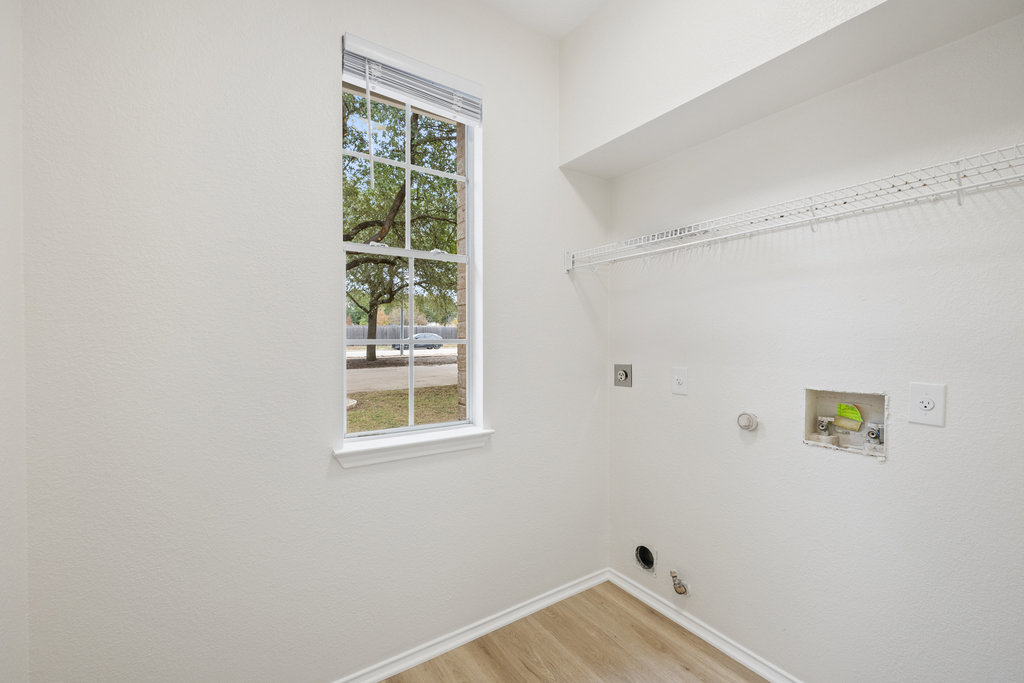 1305 Tudor House Road Pflugerville, TX 78660 - Photo 21 of 40 The laundry area is thoughtfully placed and well sized, making everyday routines simple and organized.
