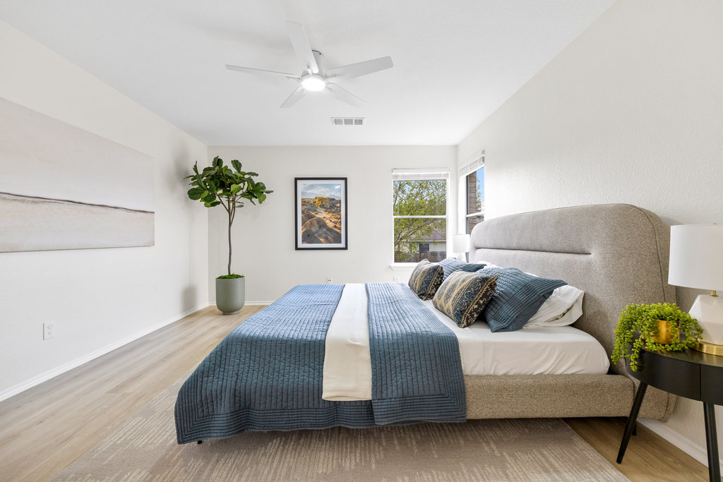 1305 Tudor House Road Pflugerville, TX 78660 - Photo 22 of 40 Neutral tones and wide plank flooring create a serene primary suite that feels both spacious and grounded.