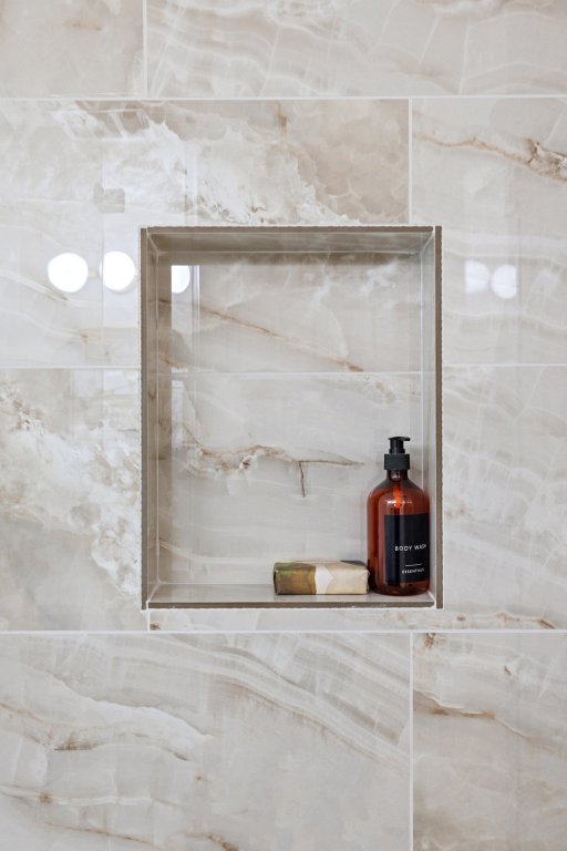 1305 Tudor House Road Pflugerville, TX 78660 - Photo 27 of 40 Even the smallest details shine, with beautifully tiled shower niches that balance function and design.