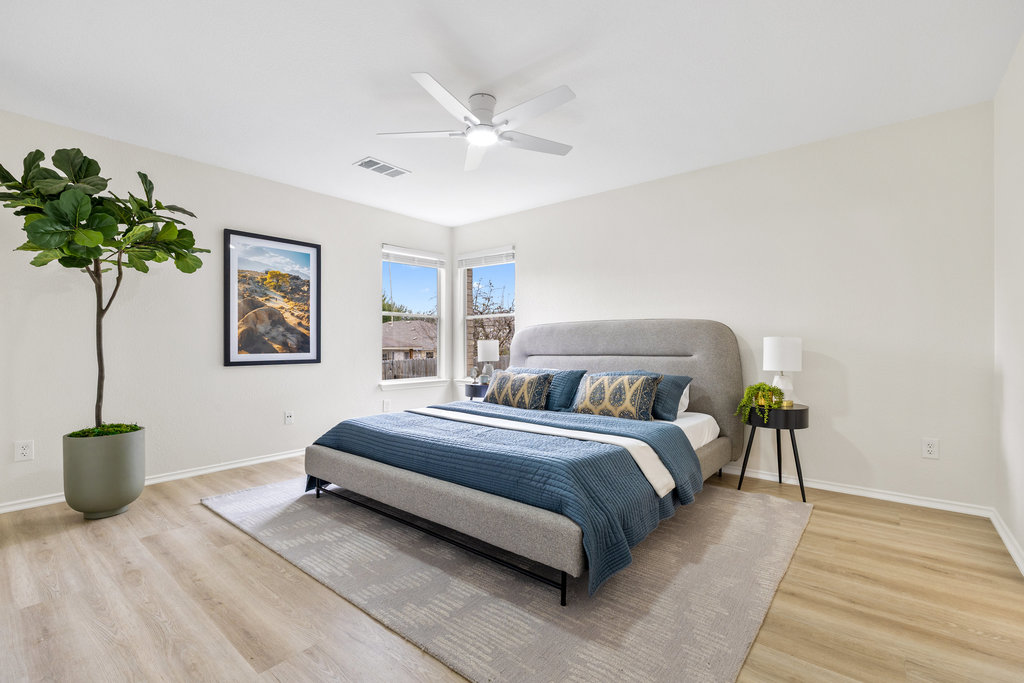 1305 Tudor House Road Pflugerville, TX 78660 - Photo 4 of 40 The primary bedroom offers a calming retreat with generous proportions, soft light, and a layout designed for rest and relaxation.