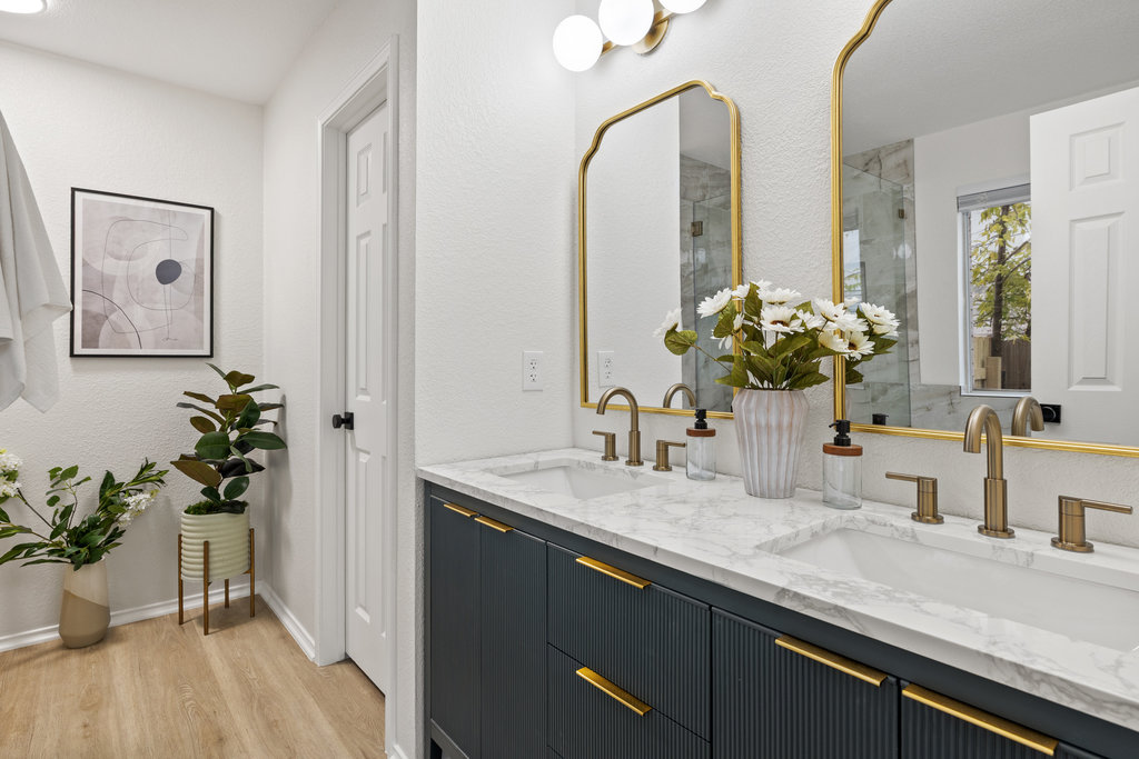 1305 Tudor House Road Pflugerville, TX 78660 - Photo 5 of 40 Beautiful stone counters, custom cabinetry, and lighting that feels straight out of a boutique hotel.