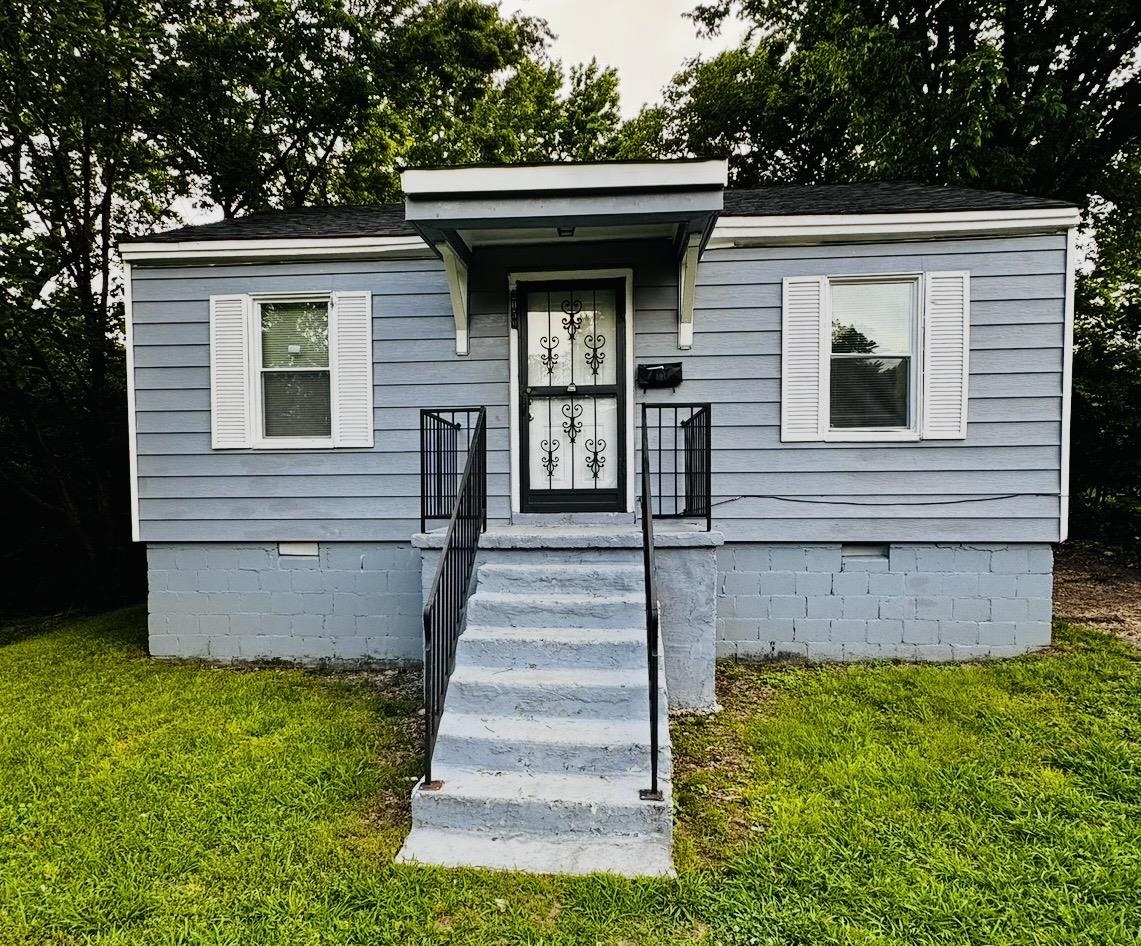 2059 Rile Street Memphis, TN 38109 - Photo 1 of 5 a view of a house with potted plants and a yard