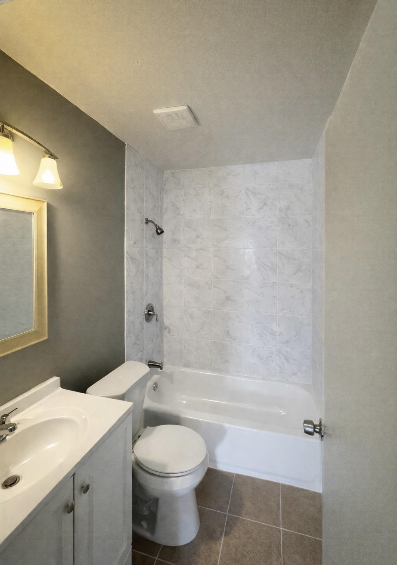 2059 Rile Street Memphis, TN 38109 - Photo 3 of 5 a bathroom with a sink a toilet and shower