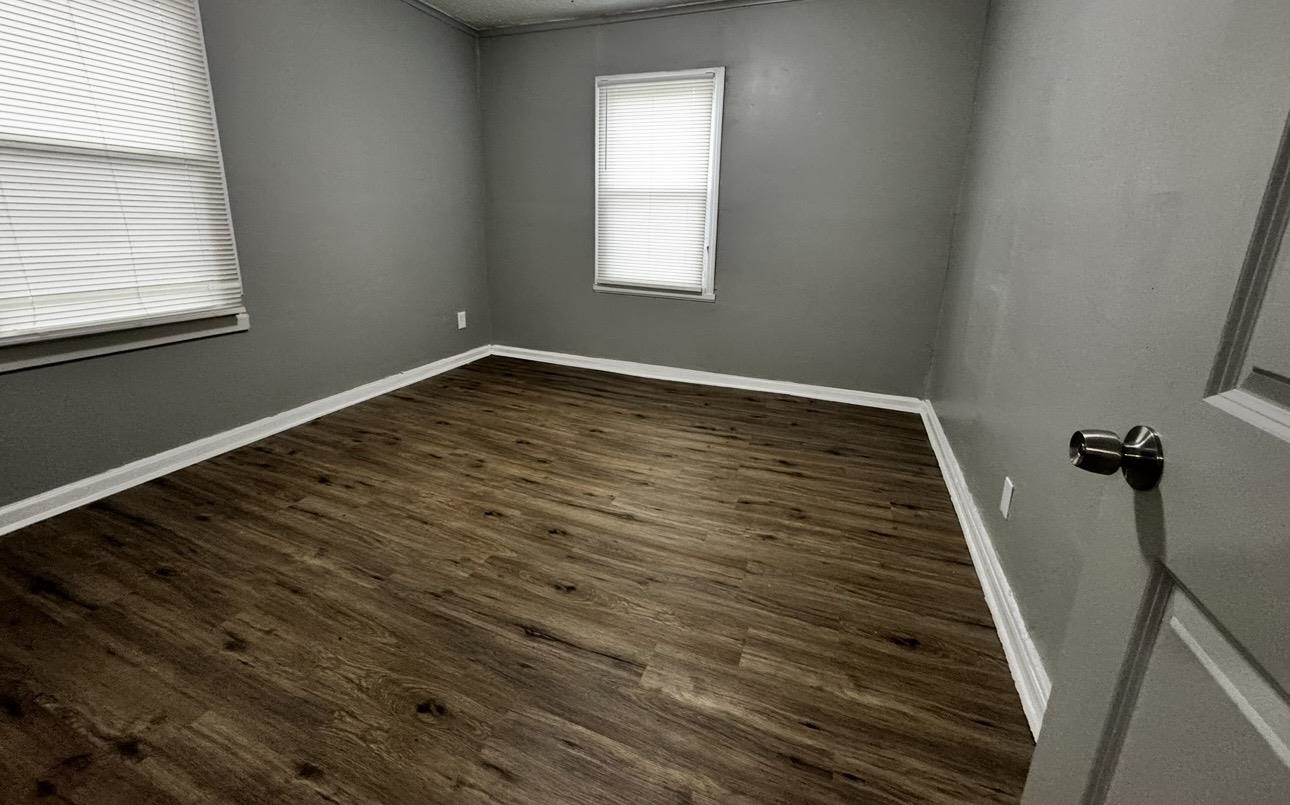2059 Rile Street Memphis, TN 38109 - Photo 4 of 5 a view of a room with wooden floor and window