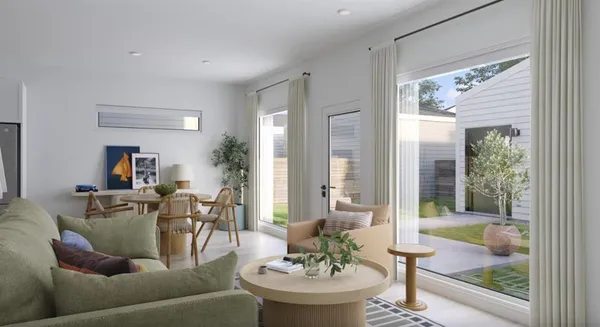 a kitchen with stainless steel appliances granite countertop a dining table chairs refrigerator and microwave