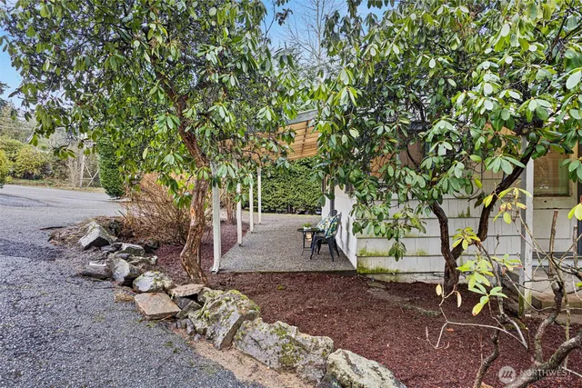 a kitchen with stainless steel appliances granite countertop a sink a stove a refrigerator and cabinets