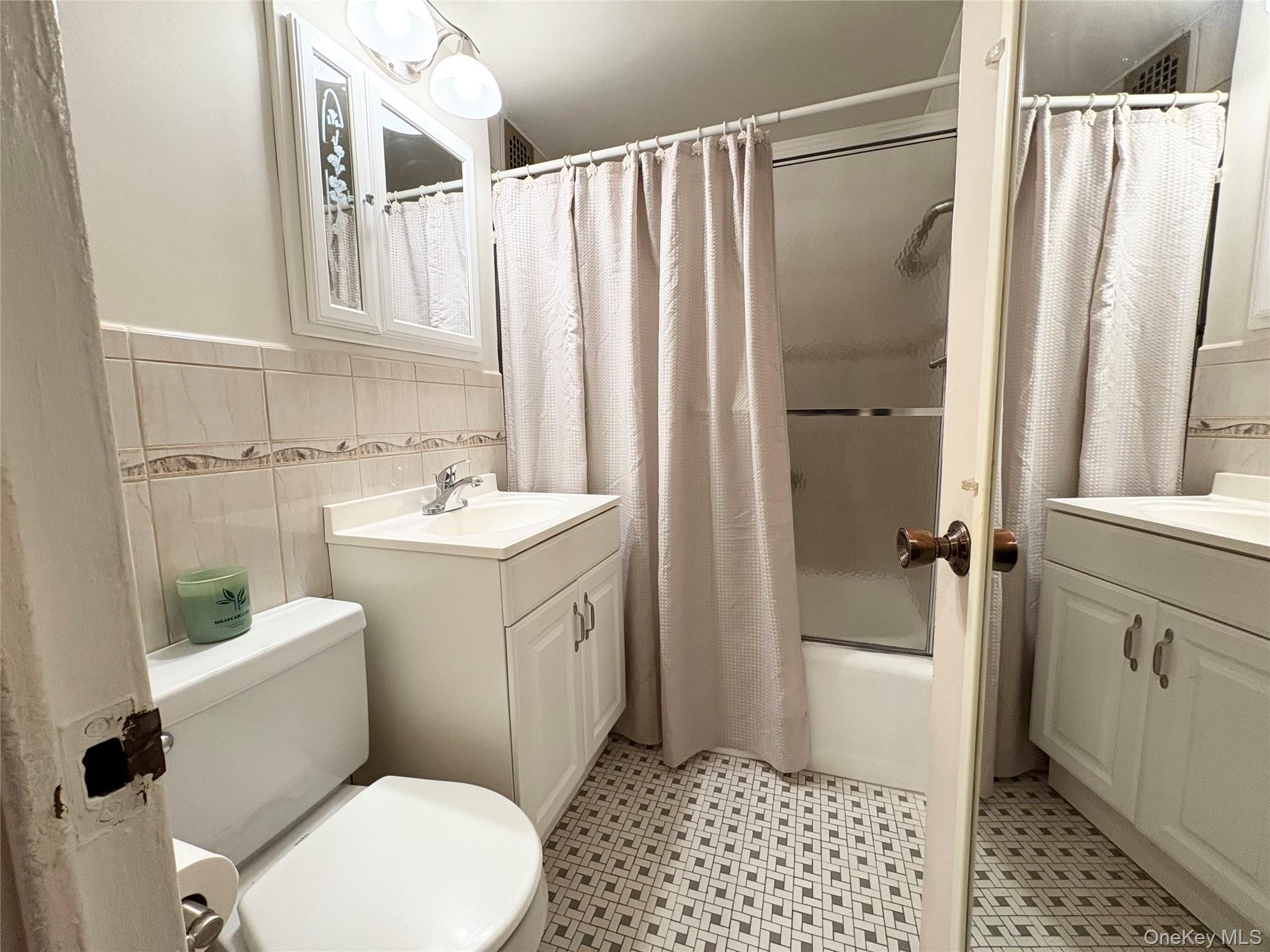 61-15 97th Street, Unit LC Queens, NY 11374 - Photo 9 of 27 a bathroom with a sink toilet and shower
