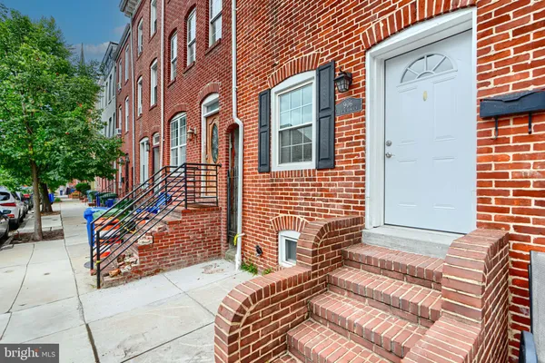a view of a brick house with many windows