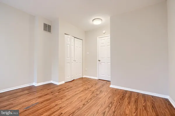 a view of a room with wooden floor