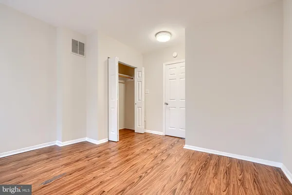 a view of a room with wooden floor and bathroom