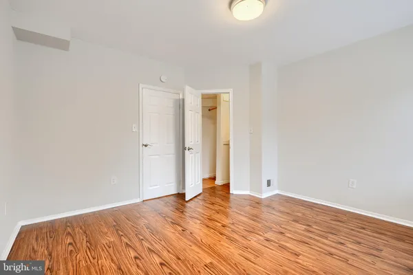 a view of a room with wooden floor and white walls