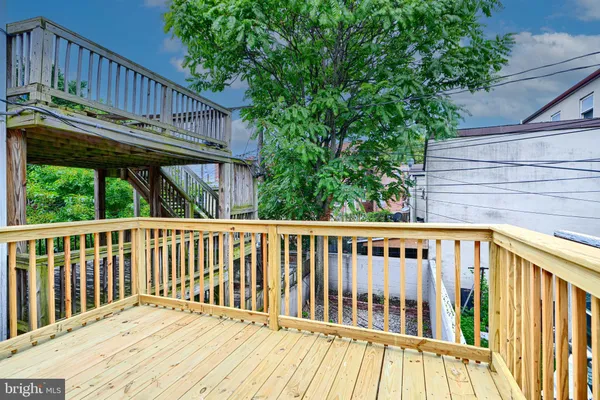 a view of wooden deck and a backyard