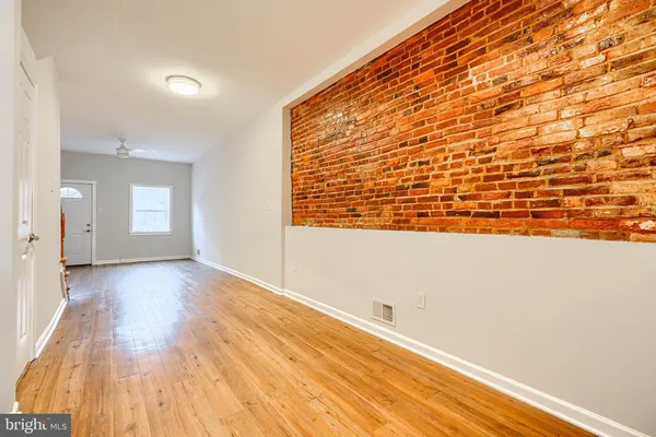 a view of an empty room and wooden floor