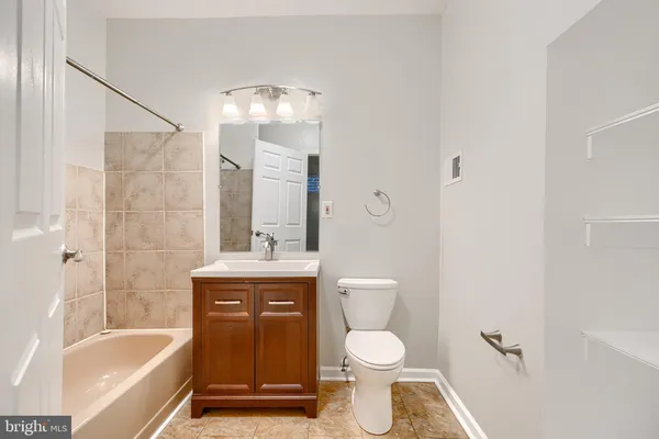a bathroom with a toilet a sink and a bathtub