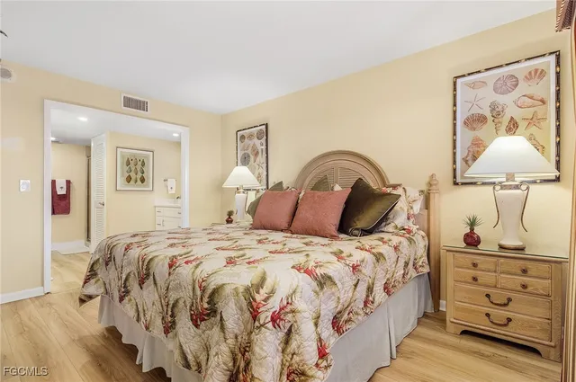 a bedroom with a bed and a lamp