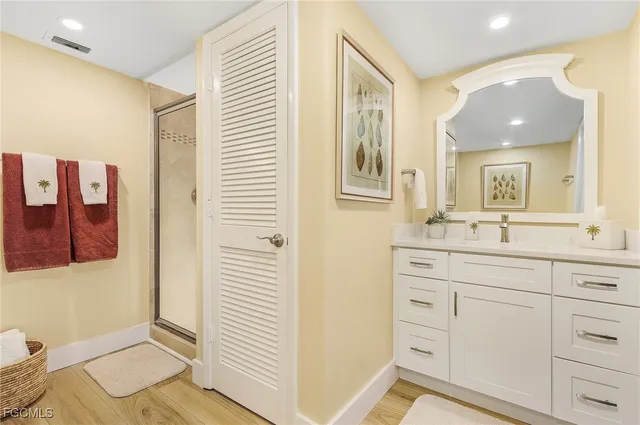 a bathroom with a sink a mirror and a shower