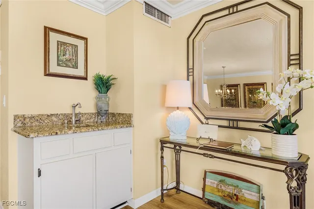 a bathroom with a granite countertop sink a mirror and vanity