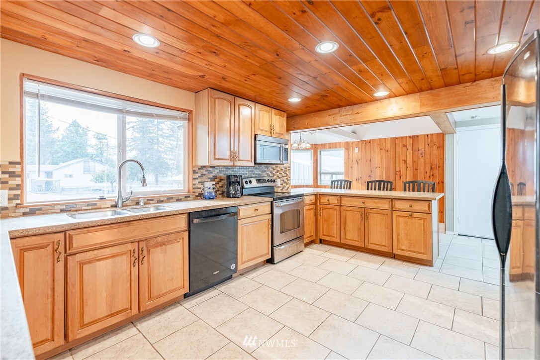 3826 Sapp Road Southwest Olympia, WA 98512 - Photo 12 of 39 a kitchen with a sink window and white cabinets