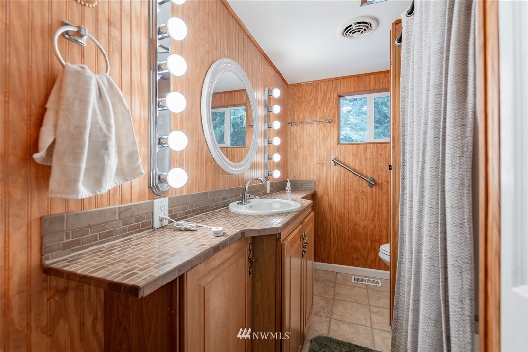 3826 Sapp Road Southwest Olympia, WA 98512 - Photo 19 of 39 a bathroom with a granite countertop sink and a mirror