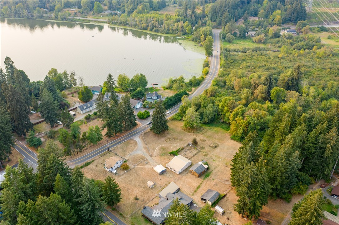 3826 Sapp Road Southwest Olympia, WA 98512 - Photo 36 of 39 a view of a lake with beach and trees all around