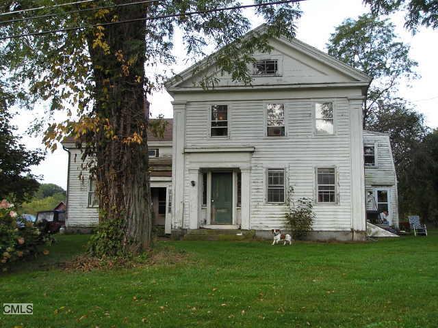 a front view of a house with a garden and yard