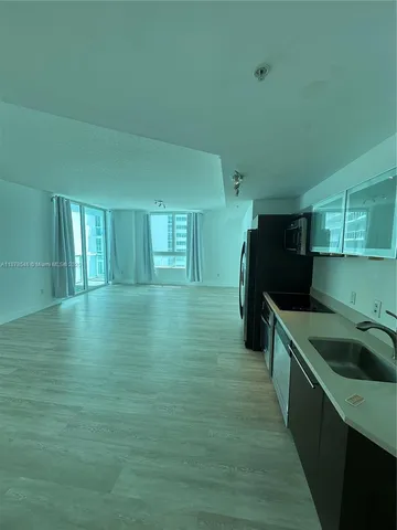 a kitchen with a sink and refrigerator