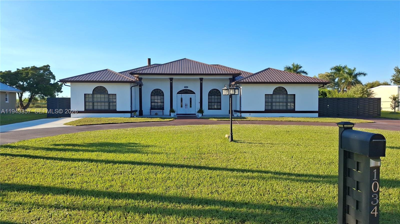 1034 Bayberry Loop Clewiston, FL 33440 - Photo 1 of 38 a front view of a house with a yard