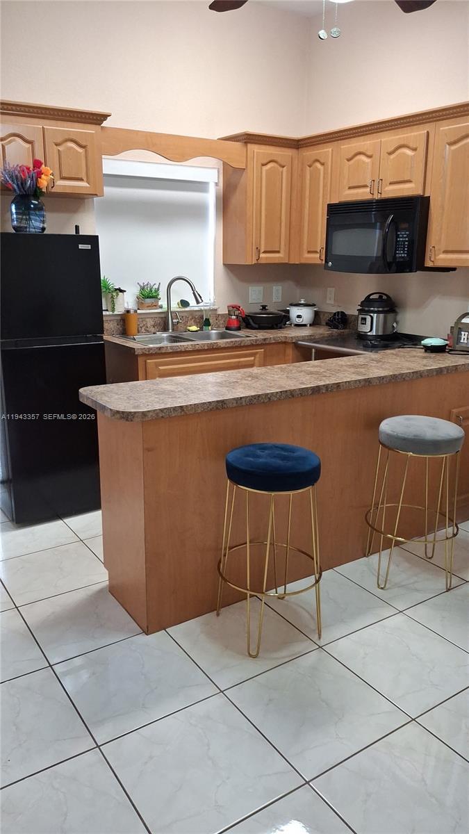 1034 Bayberry Loop Clewiston, FL 33440 - Photo 13 of 38 a kitchen with stainless steel appliances a stove a sink and a refrigerator