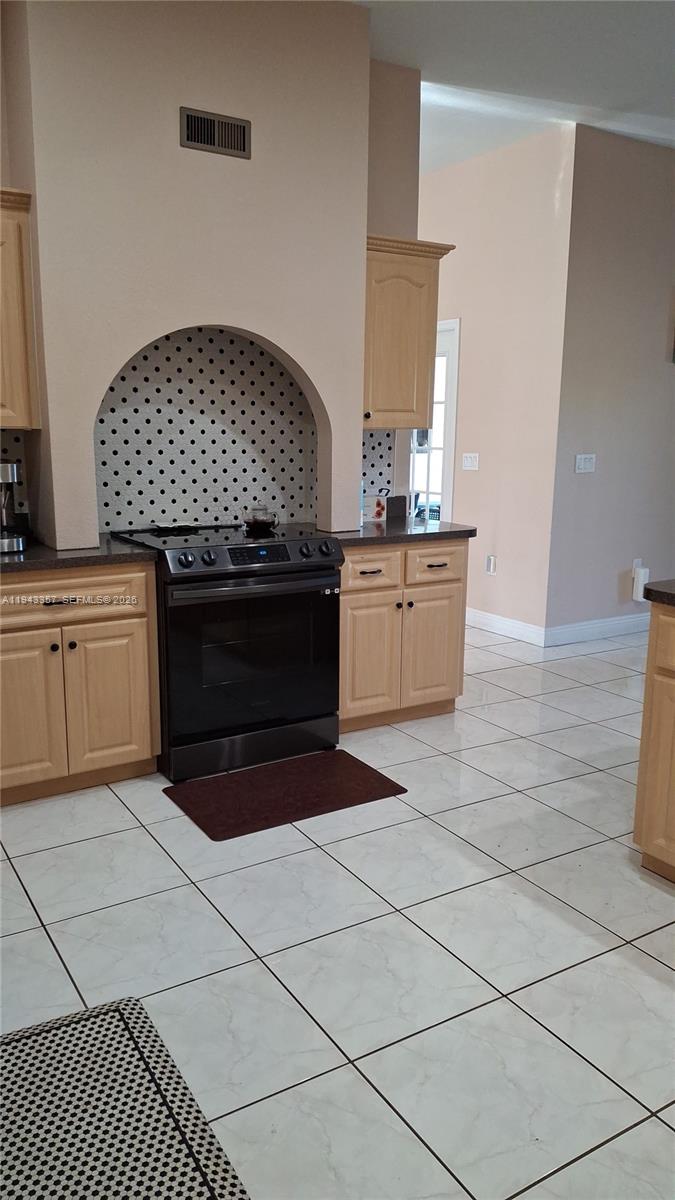 1034 Bayberry Loop Clewiston, FL 33440 - Photo 16 of 38 a kitchen with stainless steel appliances granite countertop a stove a sink and a microwave