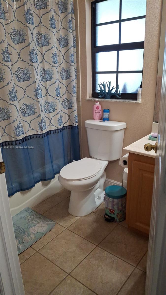 1034 Bayberry Loop Clewiston, FL 33440 - Photo 23 of 38 a bathroom with a toilet a sink and a window