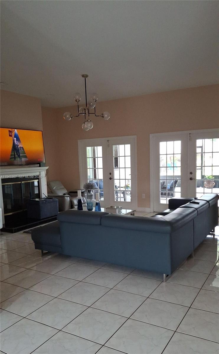 1034 Bayberry Loop Clewiston, FL 33440 - Photo 8 of 38 a living room with furniture a flat screen tv and a fireplace