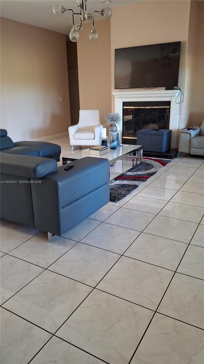 1034 Bayberry Loop Clewiston, FL 33440 - Photo 9 of 38 a room with furniture and a flat screen tv