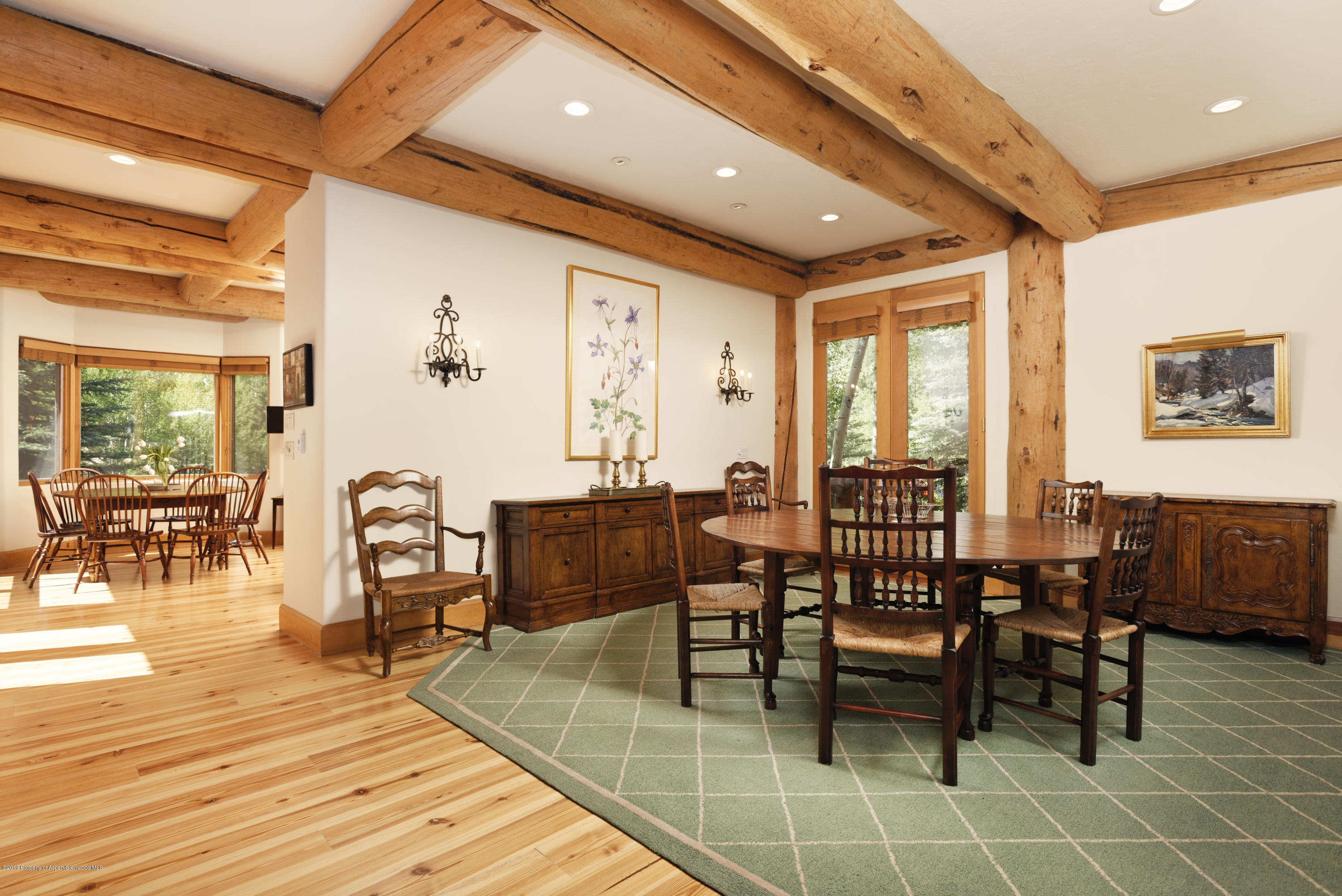 1417 Crystal Lake Road Aspen, CO 81611 - Photo 12 of 36 a dining hall with stainless steel appliances a dining table and chairs with wooden floor