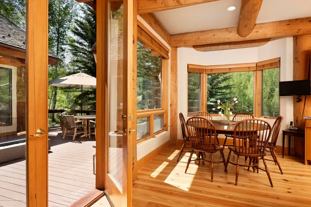 a view of a patio with table and chairs and wooden floor