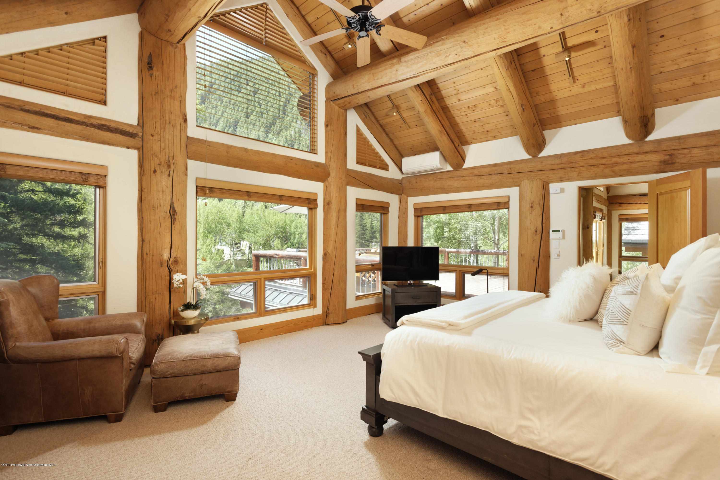 1417 Crystal Lake Road Aspen, CO 81611 - Photo 18 of 36 a bedroom with furniture and large windows