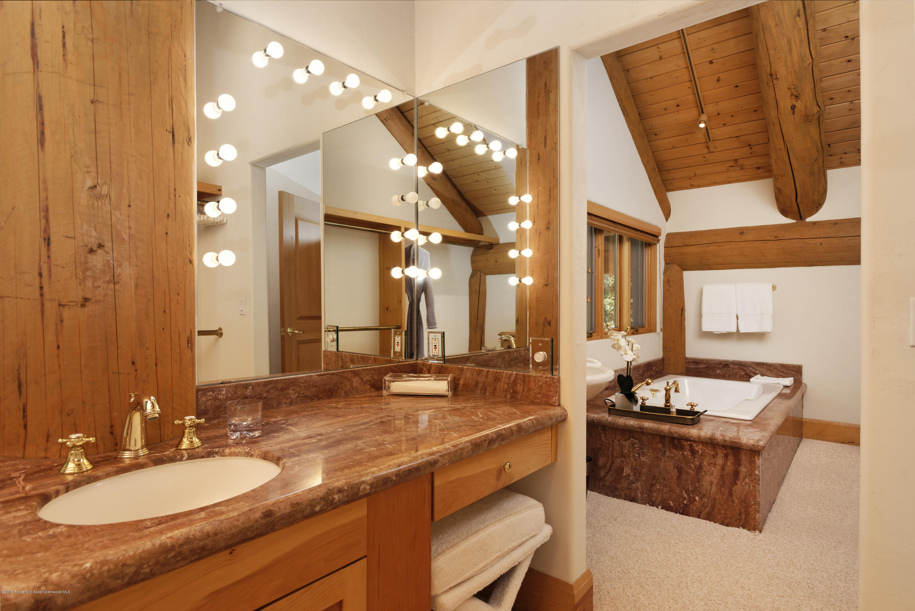 1417 Crystal Lake Road Aspen, CO 81611 - Photo 19 of 36 a bathroom with a granite countertop sink and a mirror