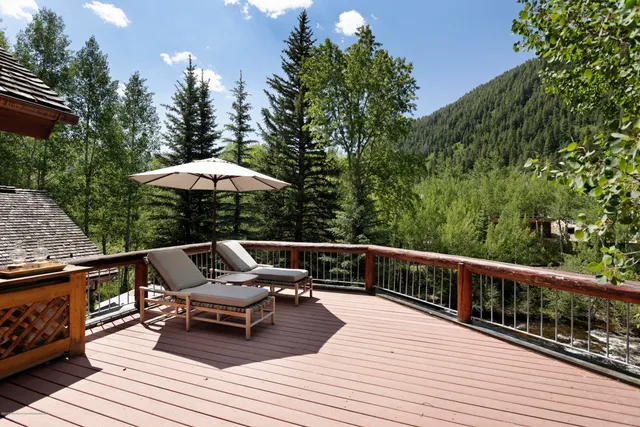 a view of a chairs and table on the wooden deck