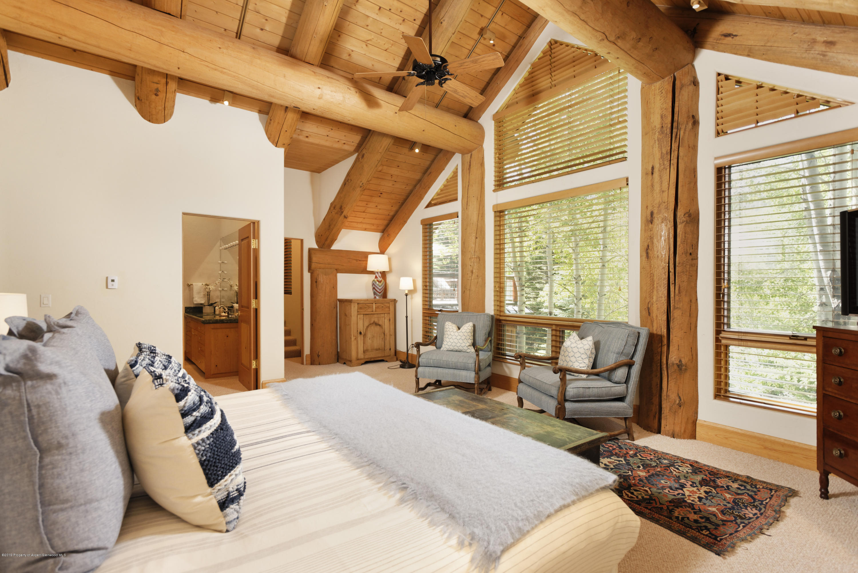 1417 Crystal Lake Road Aspen, CO 81611 - Photo 23 of 36 a large bedroom with a bed and large windows