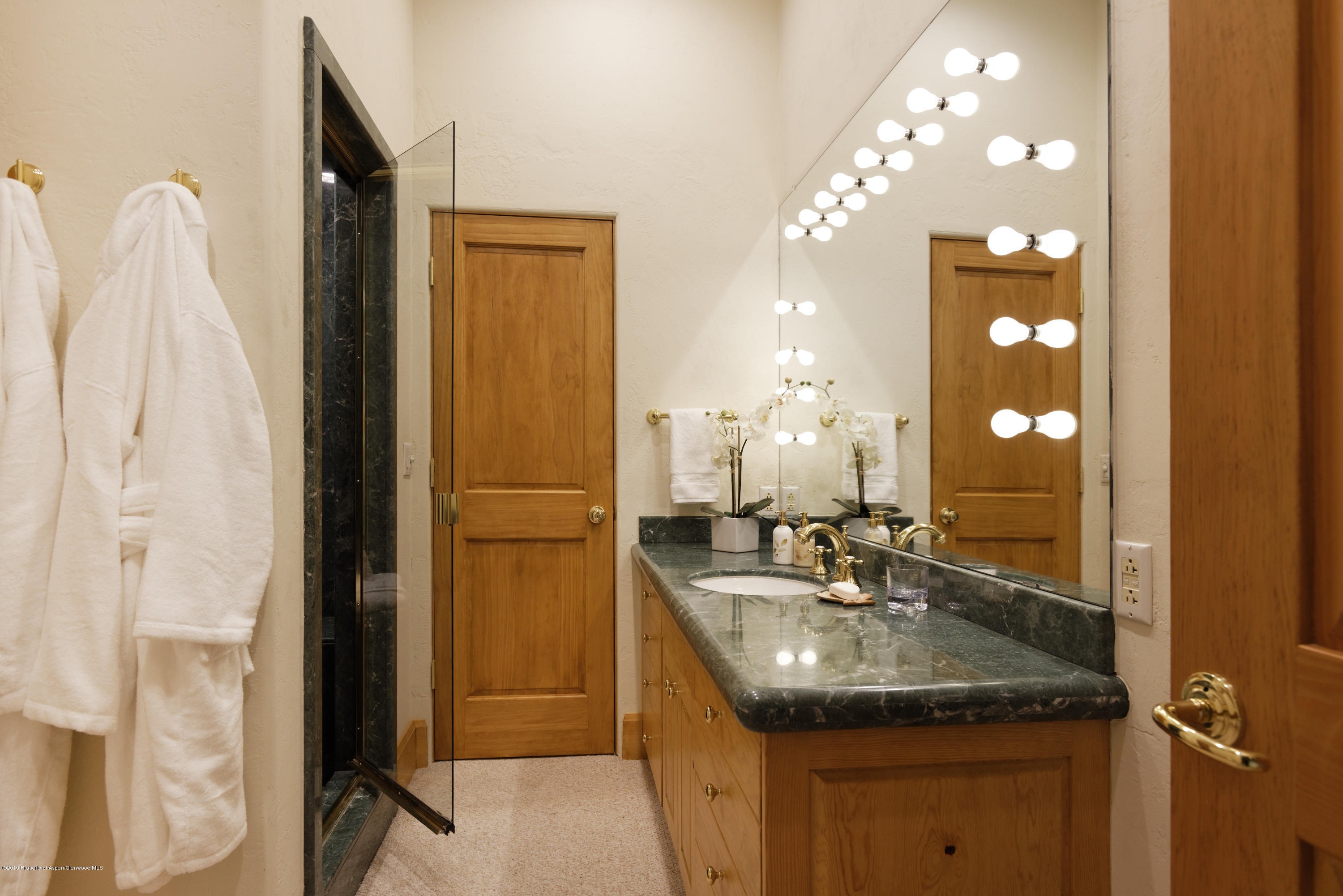 1417 Crystal Lake Road Aspen, CO 81611 - Photo 24 of 36 a bathroom with a granite countertop sink a mirror and shower