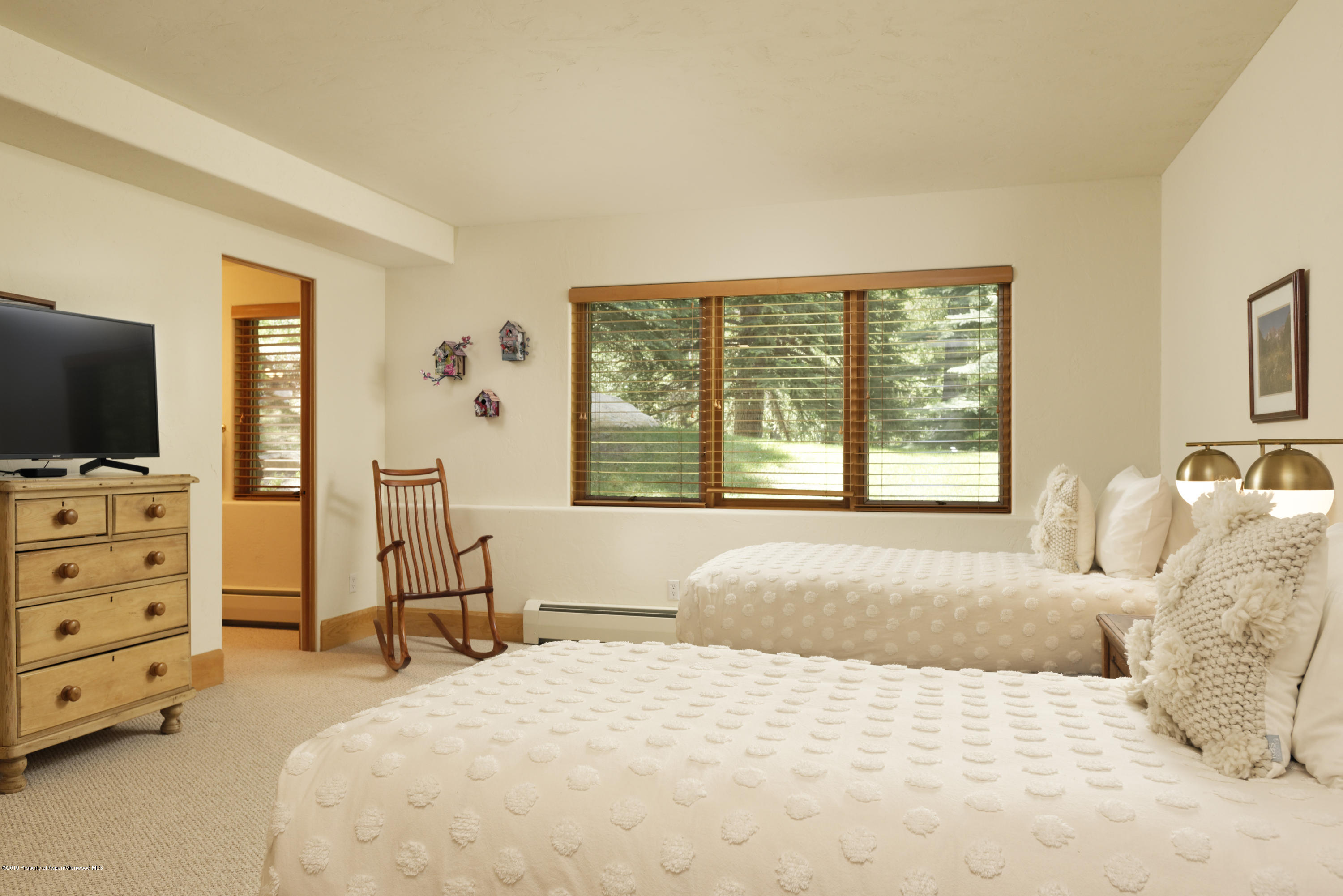 1417 Crystal Lake Road Aspen, CO 81611 - Photo 27 of 36 a bedroom with a bed and flat tv screen