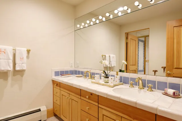 a bathroom with a double vanity sink and a mirror
