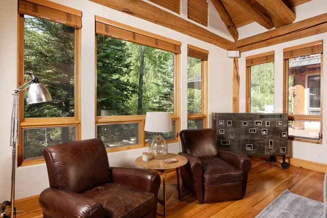 a living room with furniture and large windows