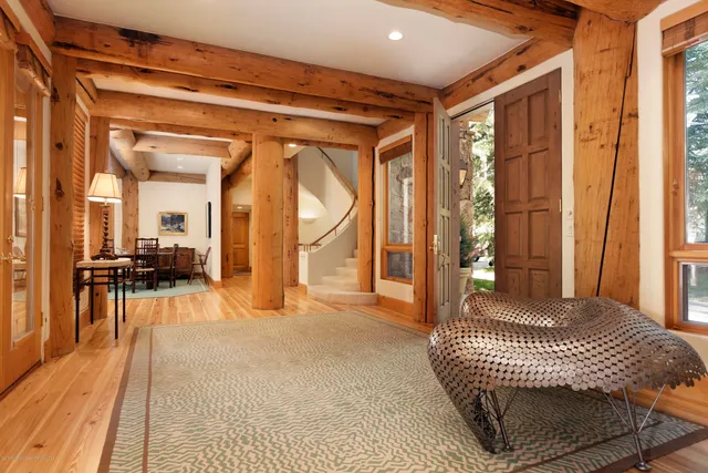 a living room with a balcony furniture and a chandelier