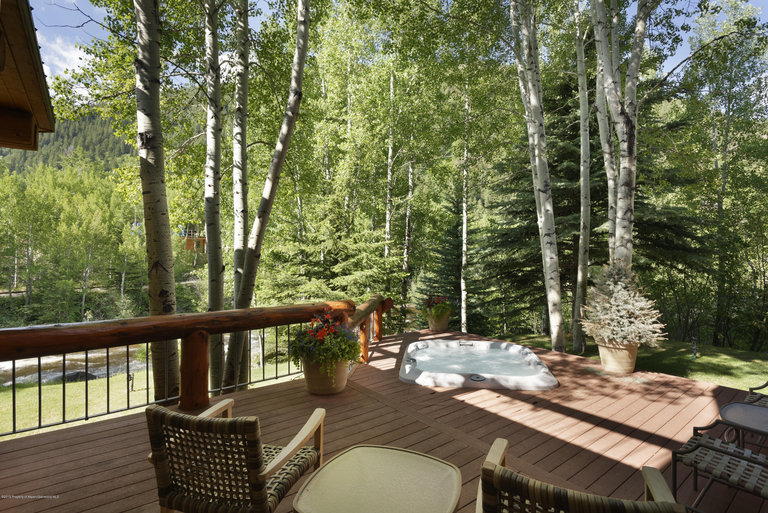 1417 Crystal Lake Road Aspen, CO 81611 - Photo 10 of 36 a view of a chairs and table on the wooden deck
