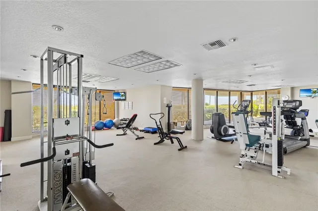 a view of a park with a multi story residential apartment building in the background