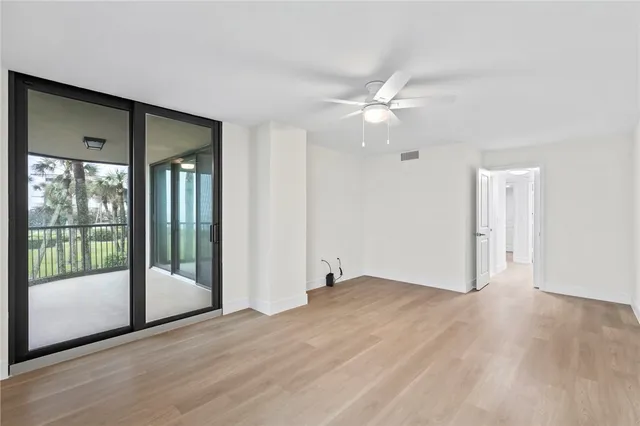 a view of an empty room with glass door