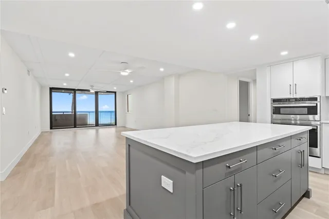 a view of kitchen with center island and stainless steel appliances