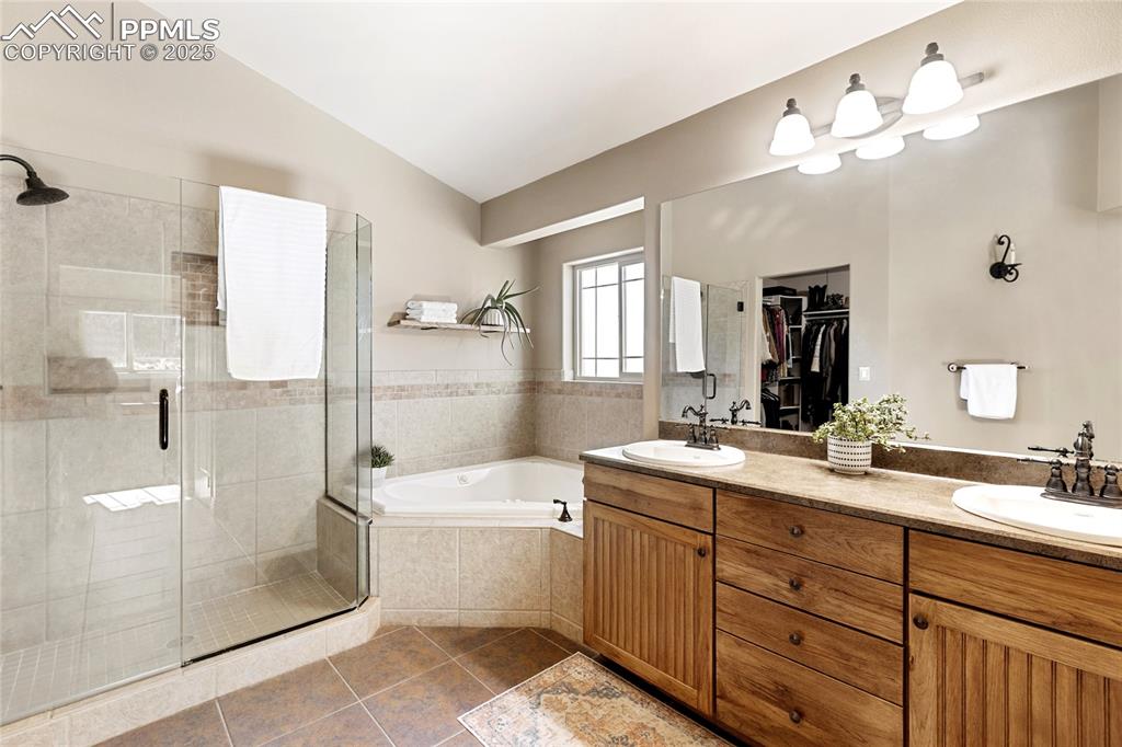 19 Worley Road Divide, CO 80814 - Photo 19 of 31 a bathroom with a double vanity sink a toilet a mirror and shower