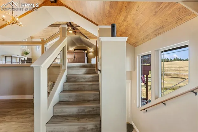 a bathroom with a sink a toilet a mirror and shower